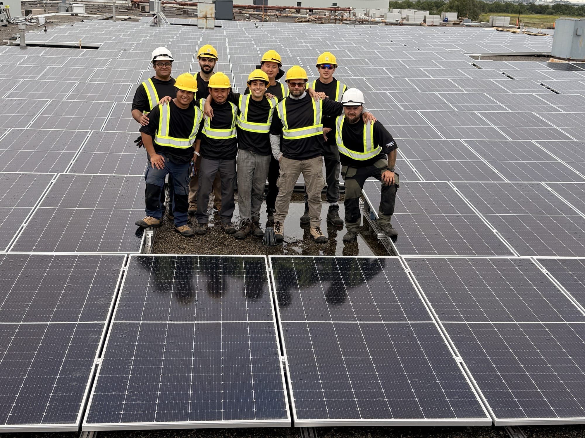 The Tero Power crew standing on a completed rooftop solar array in Mississauga